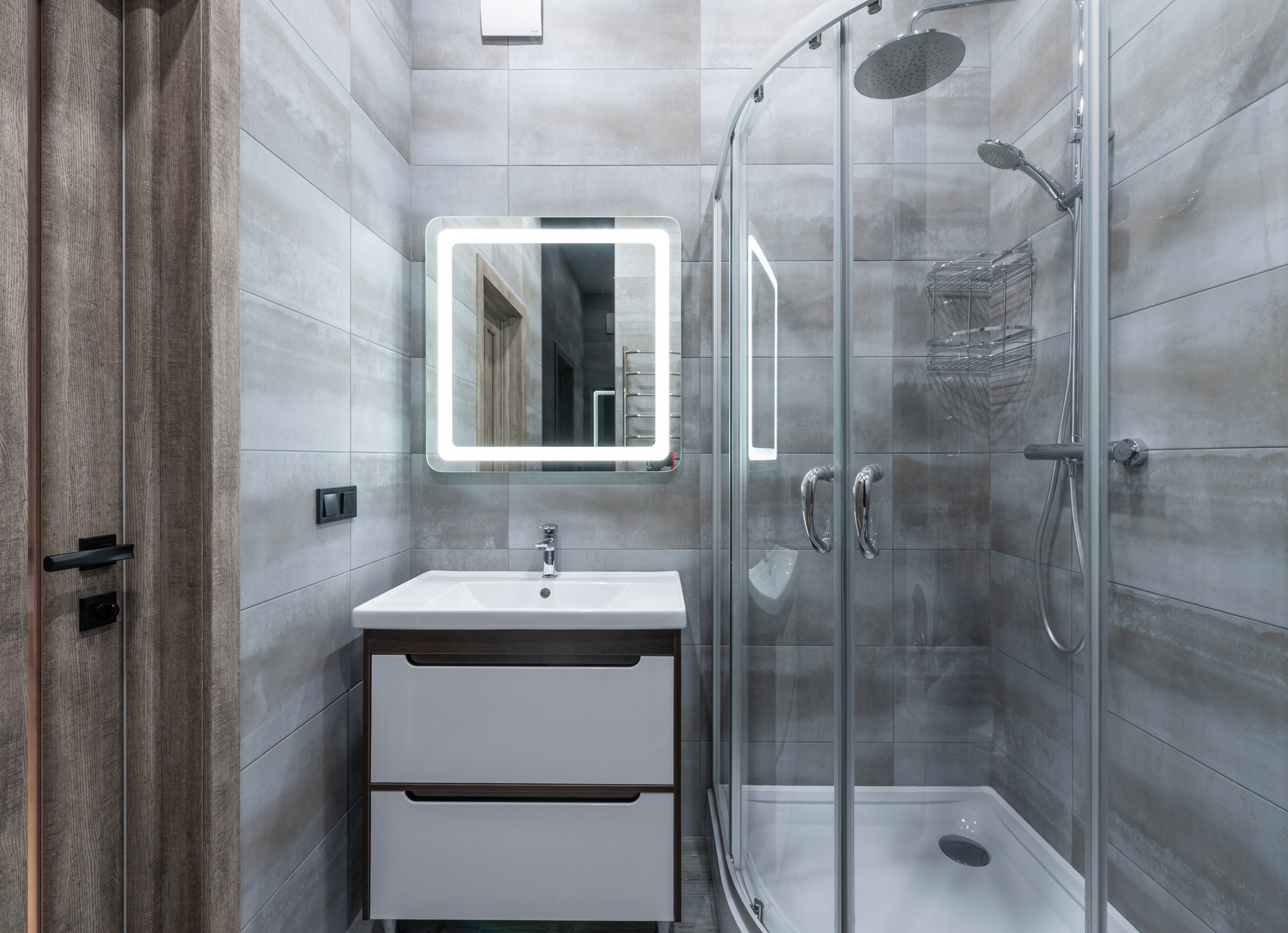 Modern bathroom interior with shower cabin in house